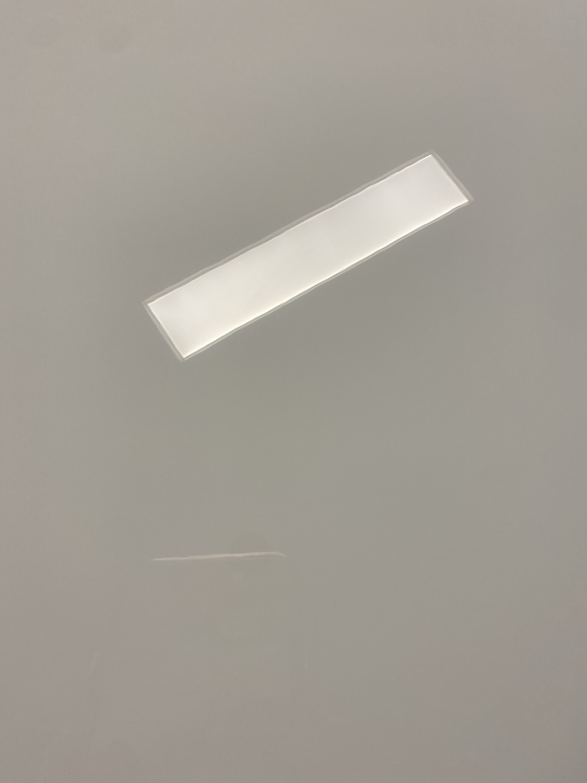 Close-up of glossy white paint showing clear overhead light reflection.